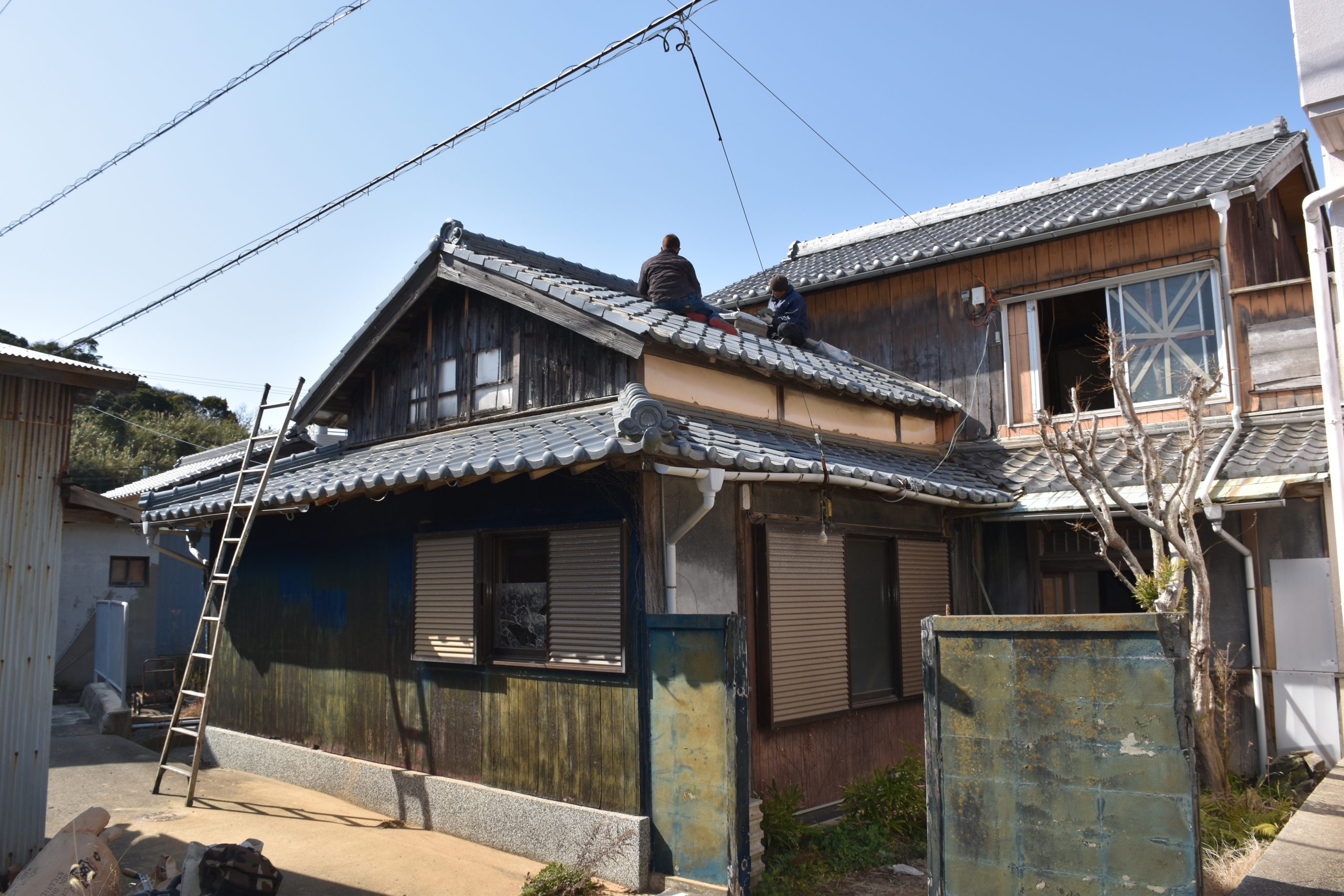 Roof tilers reseating kawara tiles on a traditional kominka property on Nushima Island, Awajishima