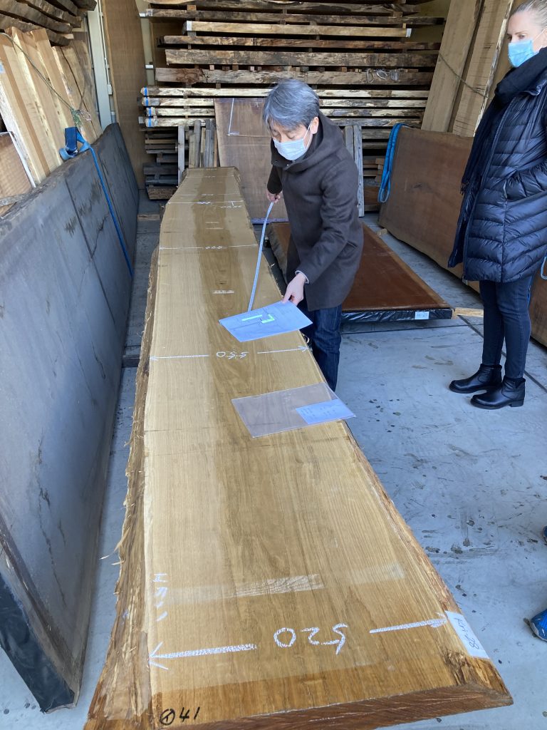 A local craftsman measuring out wood before cutting.