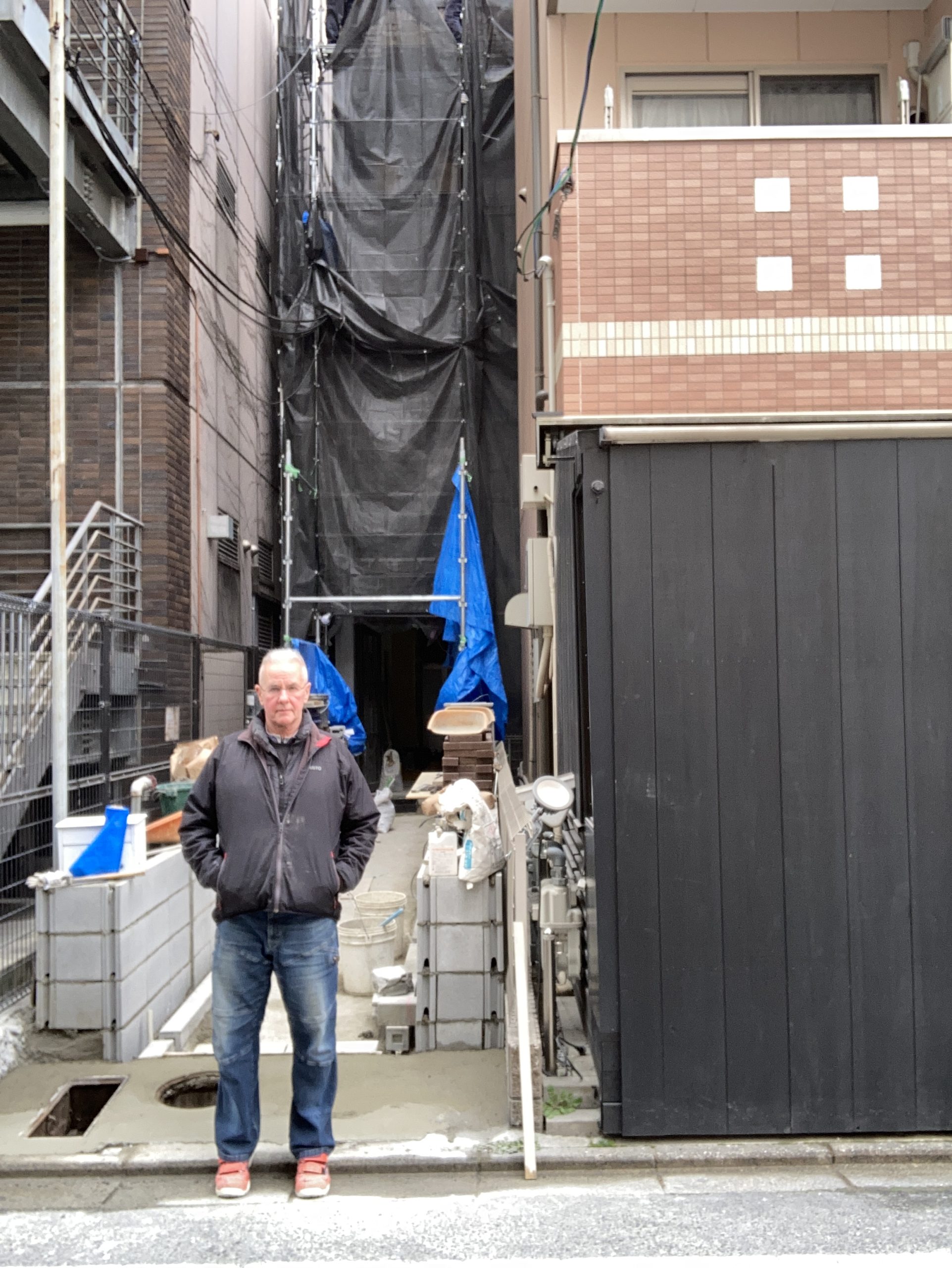 Mark Smith at the narrow laneway entrance to a high-investment three-floor commercial renovation