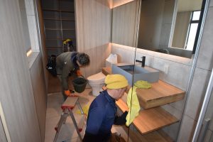 Araiya-san cleaning large glass windows on a modern architect home in Awaji Japan